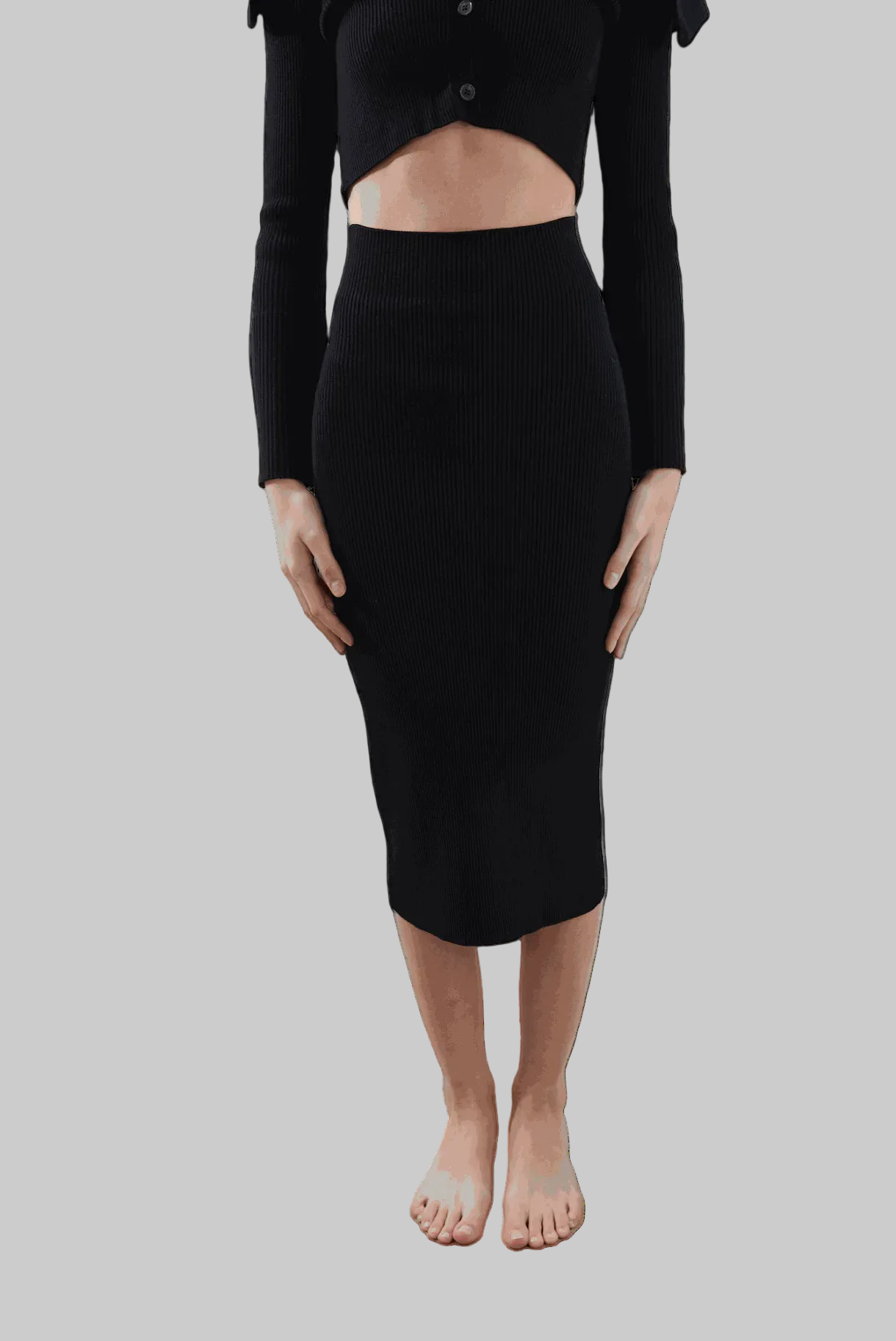 Juno Pencil Skirt in black, eco-friendly, shin-length design, worn by model showing seamless contour fit.